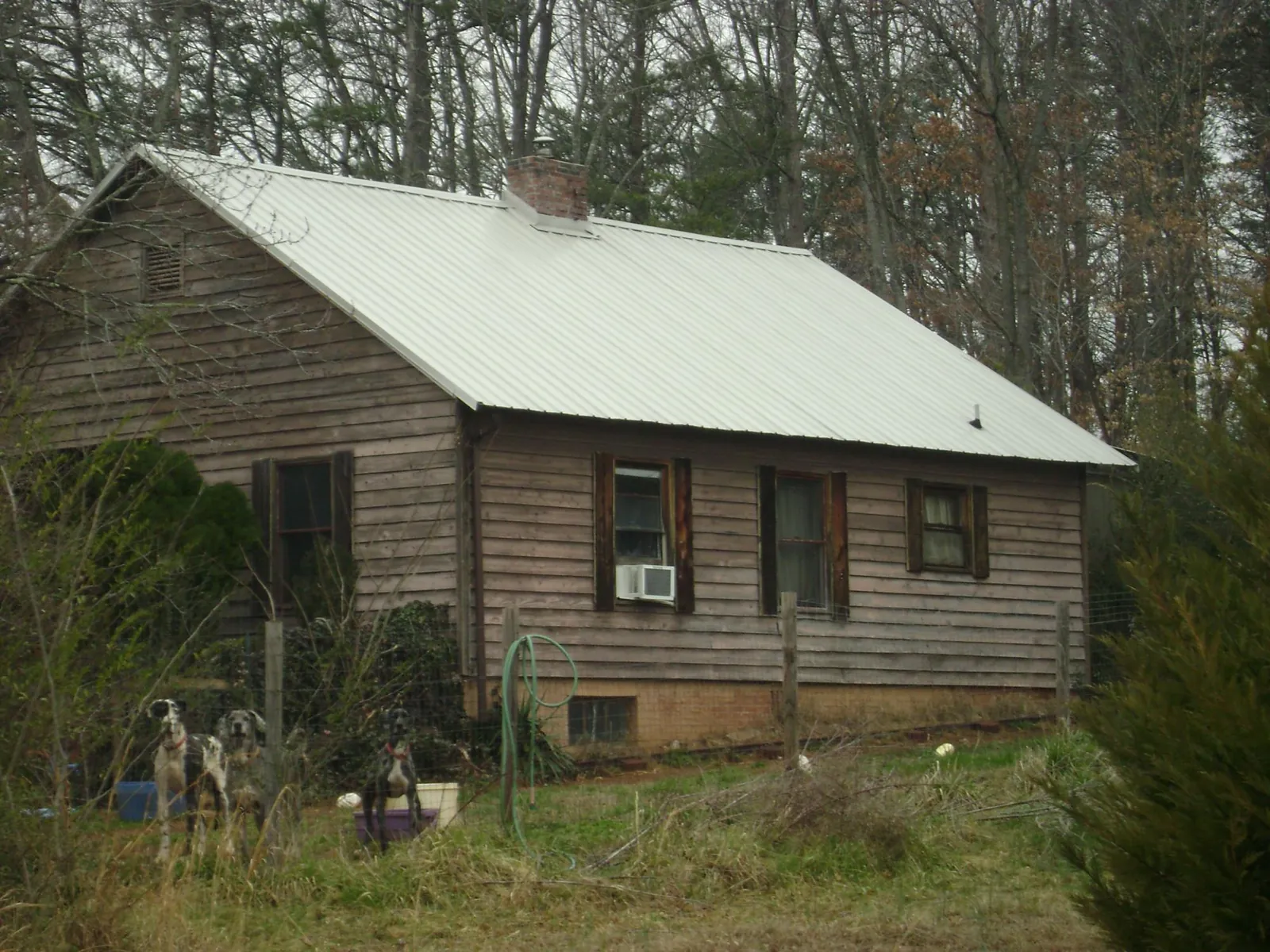White metal roof on an old wood sided farmhouse, from a Metal Roof Installation job in Haskins